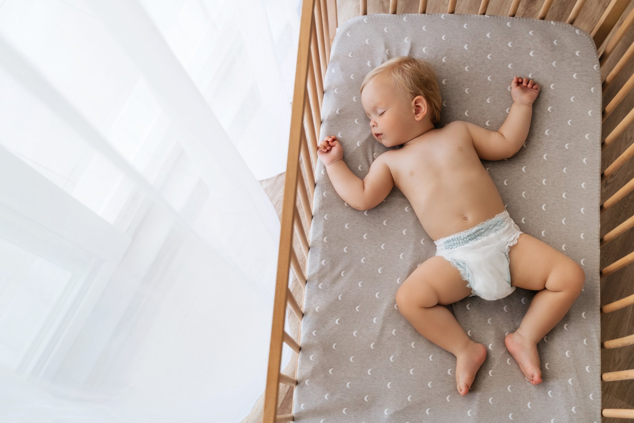 photo of a baby sleeping in its crib