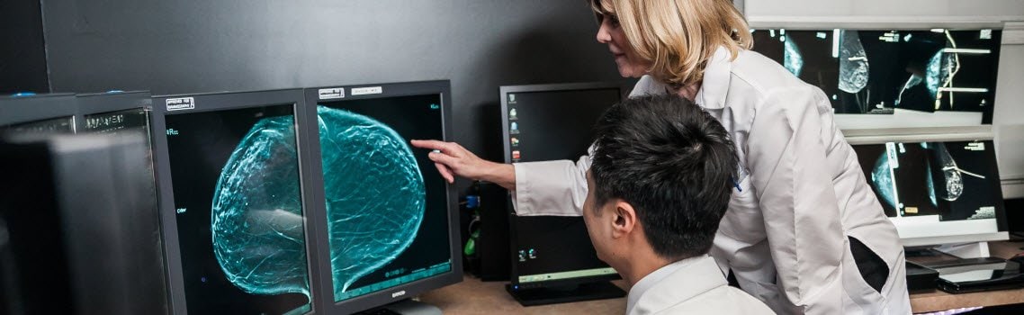 Photo of Dr. Jensen and Dr. Kuo reviewing breast images