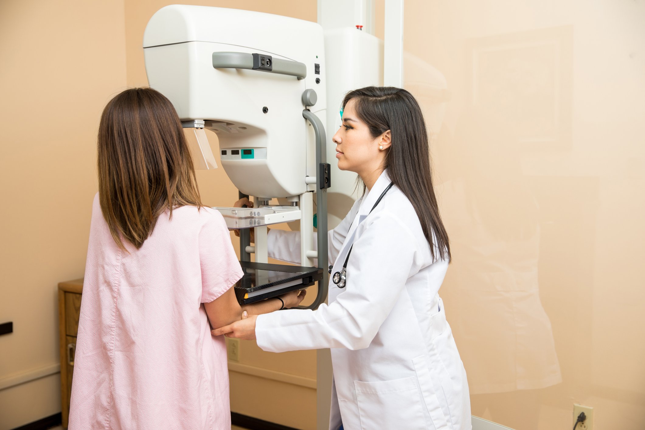 photo of a radiologist performing a mammogram on a woman