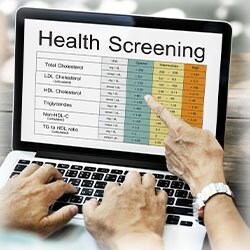 Photo of laptop displaying health screening results