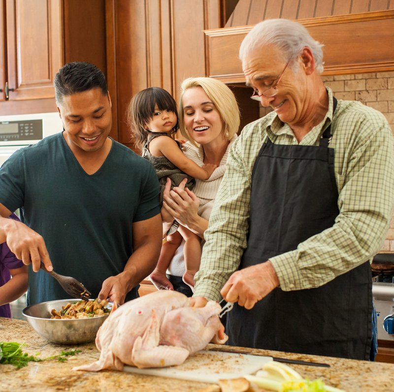 photo of a family together cooking thanksgiving dinner