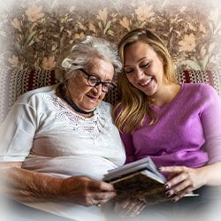 Image of woman reading with elderly woman