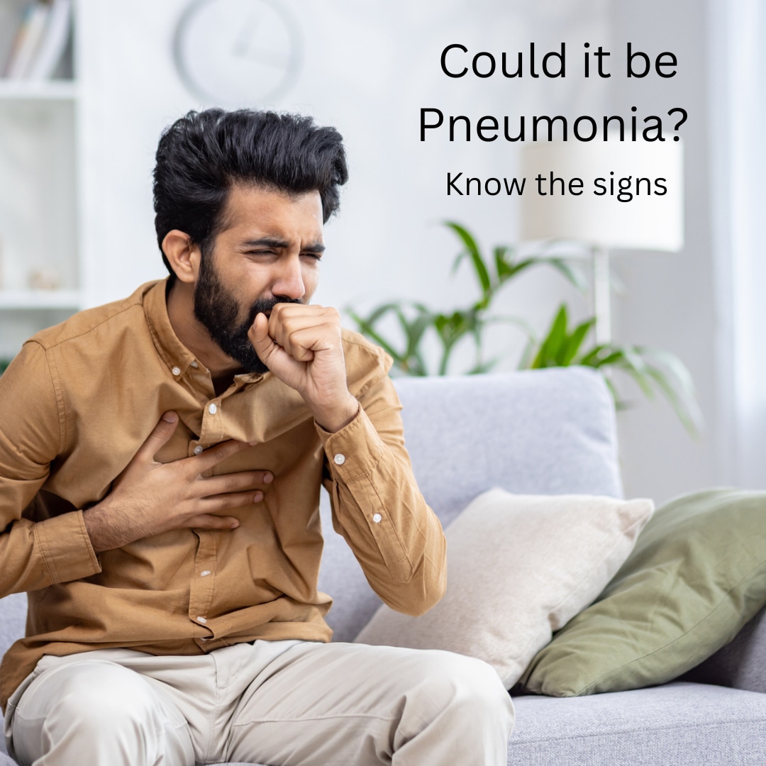 photo of man sitting on a couch and in discomfort from coughing