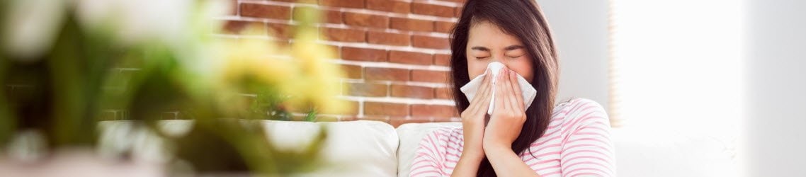 Photo of a woman sneezing