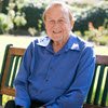 Photo of Robert Henderson sitting on a bench outdoors