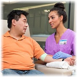 Photo of a blood donor and a nurse