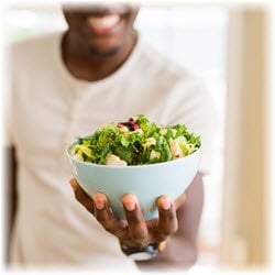 Photo of a salad bowl held in a man's hand