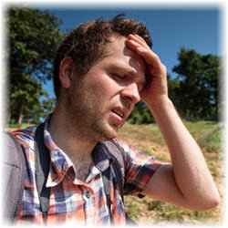 Photo of a man experiencing heat stroke while on a hike