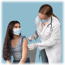 Photo of a doctor giving a teenaged girl a vaccine in her arm