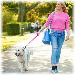 Photo of woman walking her dog