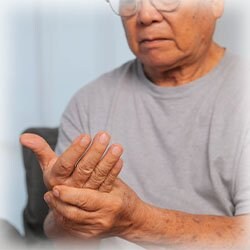 Photo of man holding his hand