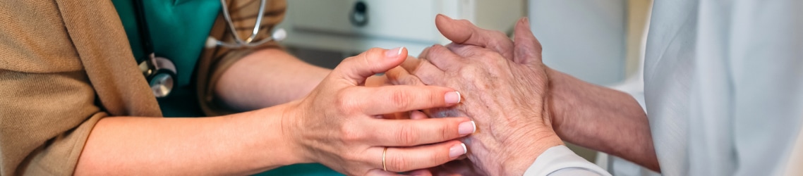 Photo of nurse holding hands with doctor