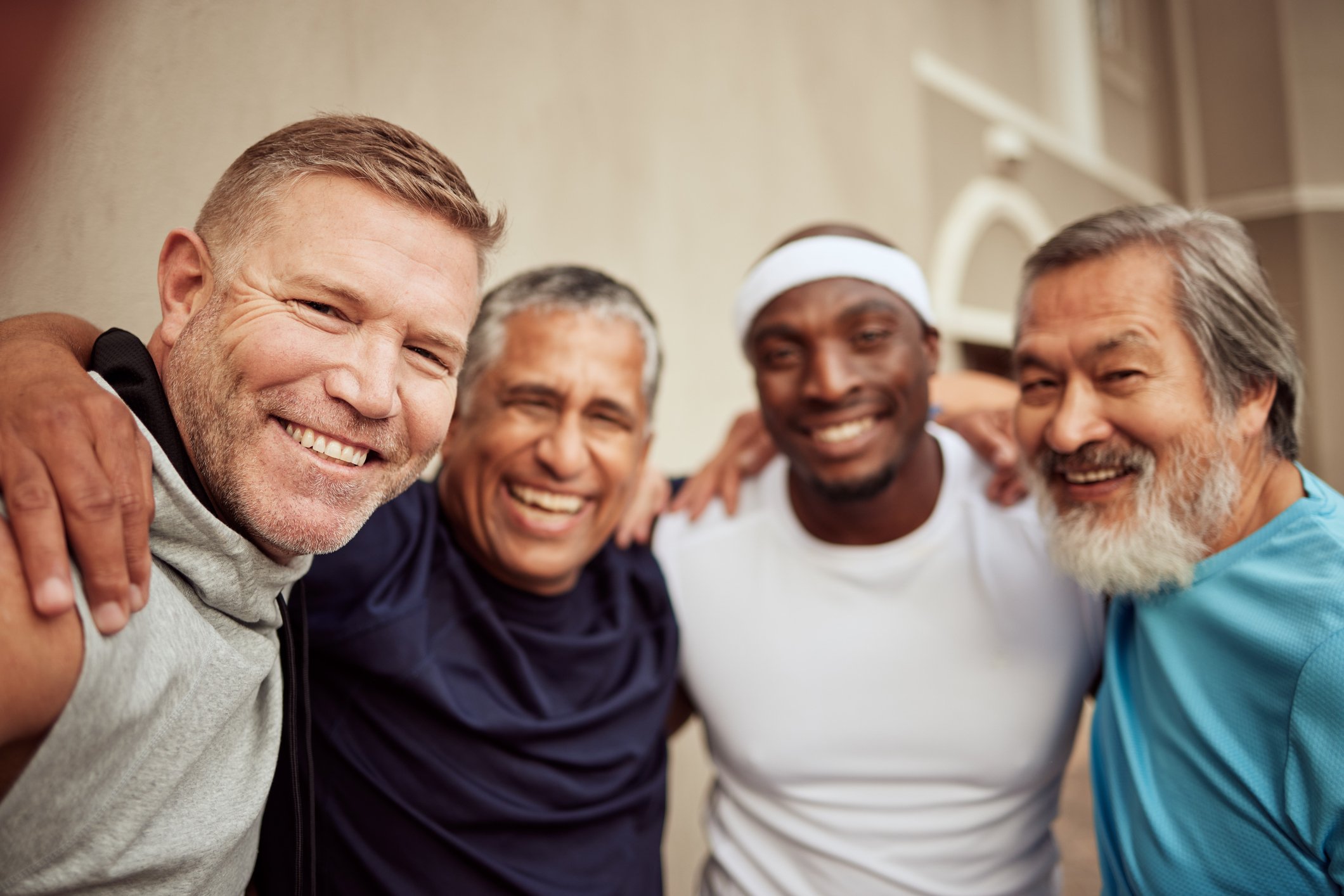 Photo of group of men gathered together to take a selfie