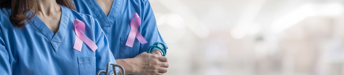 Photo of two doctors wearing Breast cancer awareness ribbons