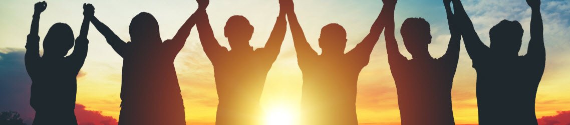 Photo of group holding hands in the air