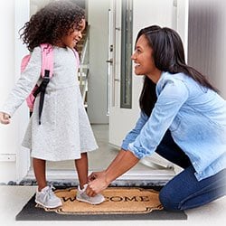 Mom getting child ready for school 